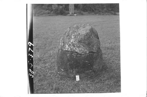 Stone figure (head missing) deliniated upon a boulder (Front)