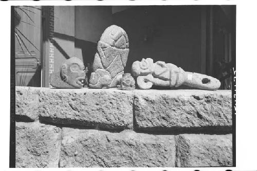 1)Fine profile stone head with tenon, 2)Metate with carved underside, 3)Plumbate