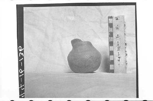 Small monoch. fragmentary bottle or jar.  Shallow-round base.  Rim gone.