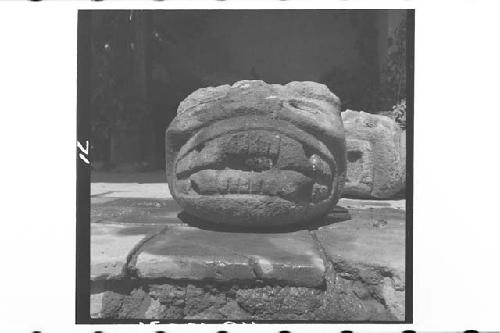 Ruins of Chalchitan-Stone Head from west side of Ball Court, Str. XXIII