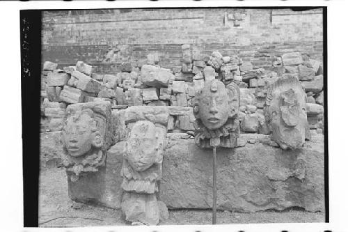 Three life-size sculptures heads and one bird head