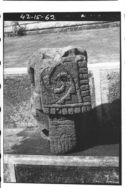 Stone figure carrying square shield. Headless