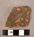 Potsherd with grooving.