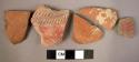 Ceramic rim and body sherds, red slipped, 1 with molded incised design