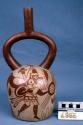 Ceramic bottle, stirrup spout, zoomorphic fighting motif with geometric designs