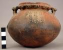 Ceramic complete jar, round bottom, 2 handles, punctate decoration, fire-clouded