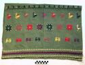 Tzute. green with white, purple, red, yellow, and blue embroidery. 88 x 62 cm.