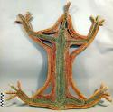 Grass and bamboo figure (frog or lizard form) plaited fibers, covered with clay