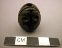 Lignite ornament - hollow, cone-shaped, carved human head designs; +