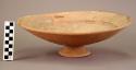 Pottery pedestal bowl - flaring hollow foot; red and black painted bands on inne