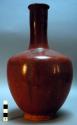 Long-necked red pottery vase with stopper