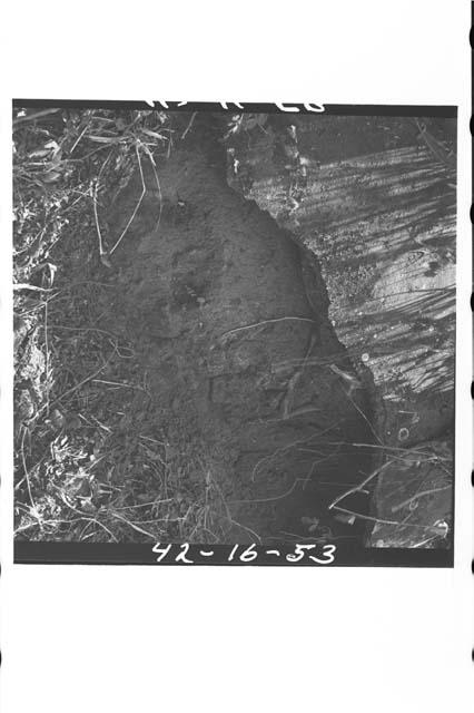 Broken, battered terrace wall of platform covering adobe construction, as expose