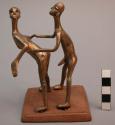 Brass figure of two people copulating.  Height: 13 cm