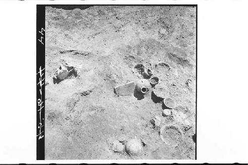 Pots 1-19 in situ with metate. Looking S. and Down. Burial A, Tomb 6, Str. 1B