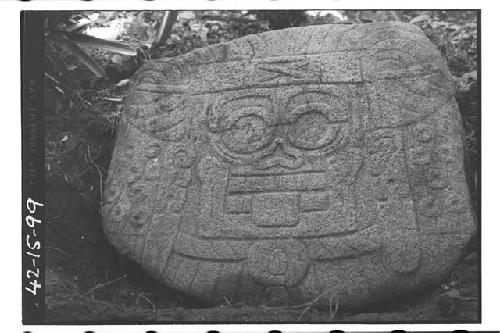 Stone slab with death head in low relief