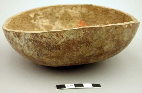 Gourd bowl containing beans and a peanut