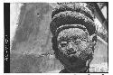 Close-up of sculptured stone head in round. Mongoloid features.