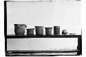 Seven varied shape vessels, part of offerings under altar to Stela J