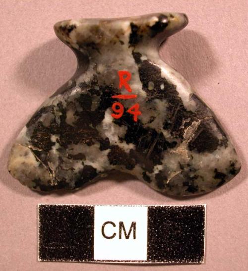 Ground syenite labret. Head is oval, flared, and concave. Shaft is flared.