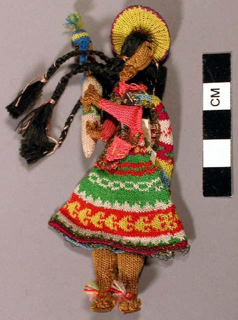 Small knitted doll in costume