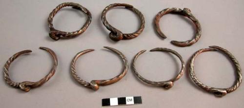 7 twisted iron bracelets with loop in center