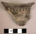Plain grey ware rim potsherd with decoration of filleted perforated