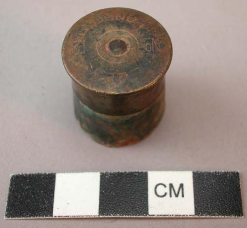 Ornament, hollowed bullet shell, possibly the end of a handle