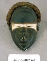 Black wooden mask with white and red around eyes and metal teeth (Longwa) -  "Su