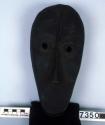 Black wooden mask resembling crocodile (Gbea Glu) - begs fish from men and fish