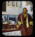 Lantern slide of monk with tea things, hand-colored