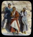 Lantern slide of bare-breasted woman and two others, hand-colored