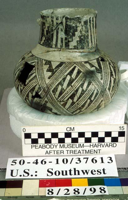 Ceramic vessel, mended & sherds.  White with black designs, effigy in neck.