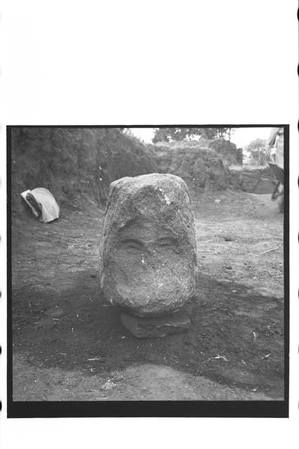 Front view of sculptured serpent head with human face in mouth