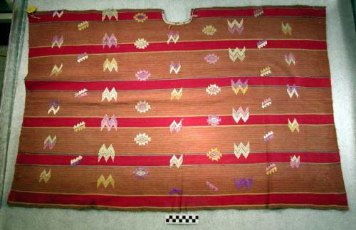 Half huipil. red background, yellow, green, white and brown stripes, purple, yel