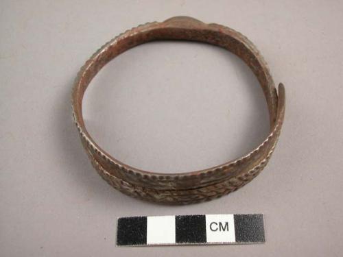 Spiral, chased iron bracelet with knob