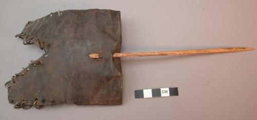 Armor? iron sheet with iron rings on edges, perforated with wood stick inserted