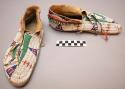 Pair of Sioux man's moccasins. Rawhide soles, soft uppers. Sewn up heel