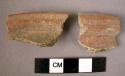 2 potsherds - shiny red painted? outside & inside; rim sherds