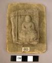 Buddhist clay plaque with seated figure of buddha in high relief