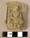 Buddhist high relief of seated figure of buddha on clay placque