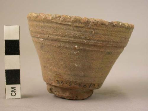 Small triangular shaped pottery vessel