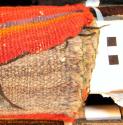 Rug or saddle blanket. Bands of red with narrow orange and purple-grey lines