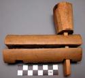 Unclassified tool, carved wood cylinder, halved, perforated; flared toggle 1 end