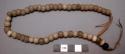 Necklace, white beads with single blue bead, olunigi lwomukala