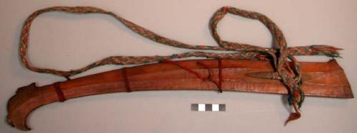 Sheath, two carved wooden planks, tied together with string, woven cotton strap