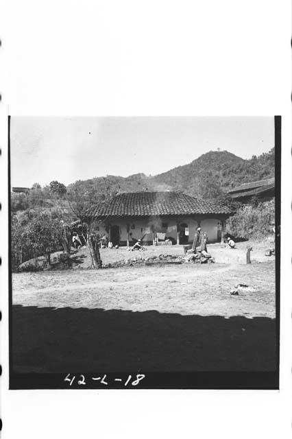 Exterior view of white-washed adobe house