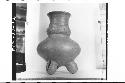 Plumbate bulging neck jar, tripod, incised.