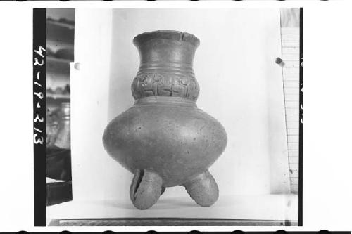Plumbate bulging neck jar, tripod, incised.