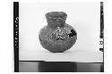 Plumbate standard jar, appliqued human head.