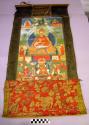 Painting, thangka, seated Lama holding sutras, royal figure below, polychrome
